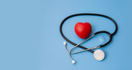 Stethoscope and red hearts on a blue background Health care concept.