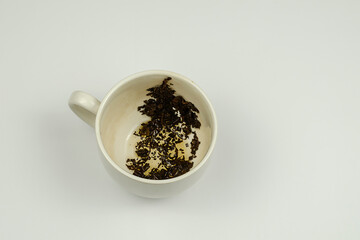 An empty dirty cup with leftover tea.