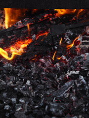Hot coals, fire and flames close up photo.Burning charcoal for a barbecue.