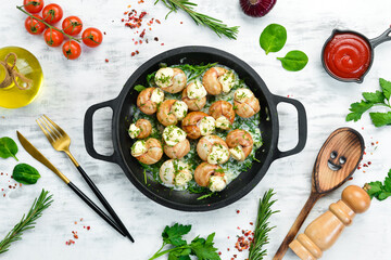 Bourgogne Escargot Snails with garlic, cheese in a creamy sauce on a black stone plate. Top view. Free space for text.
