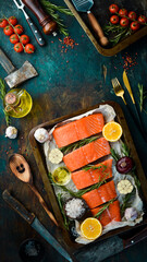 Pieces of salmon fillet with spices in a metal baking dish. Seafood. Top view. Free space for text.