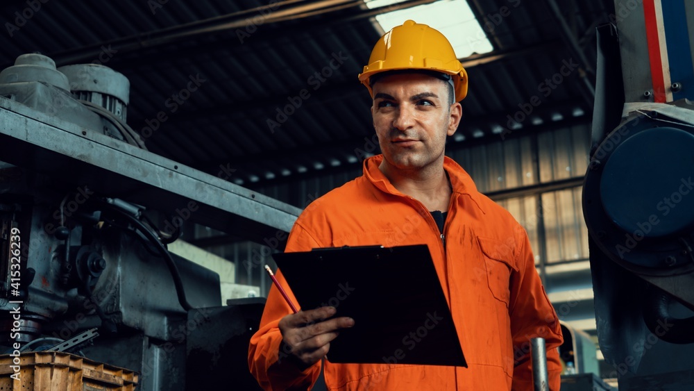 Poster skillful factory worker working with clipboard to do job procedure checklist . factory production li