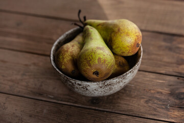 Fresh Pears In Ceramic Bowl On Wooden Table.