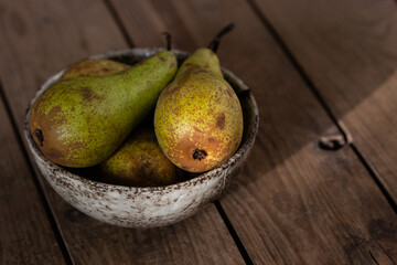Fresh Pears In Ceramic Bowl On Wooden Table.