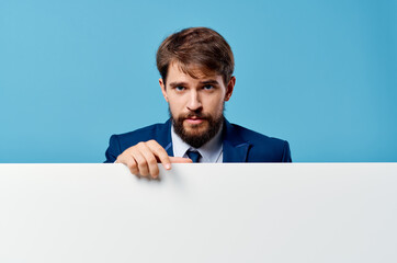 emotional business man peeking out from behind banner cropped view blue background Copy Space