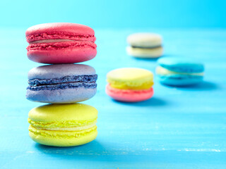 Sweet Macaron of different colors on an azure background