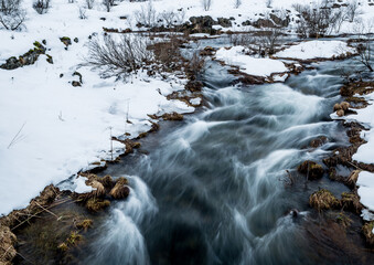 Ellidaa river stream  in Ellidaardalur valley at winter time. Reykjavik outdoor park