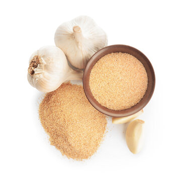 Bowl with aromatic powdered garlic on white background