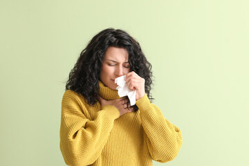Sick young woman on color background