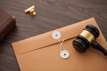 secret file with judge gavel on desk.