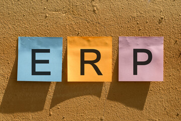 ERP (Enterprise resource planning) word from colorful paper notes on wall.