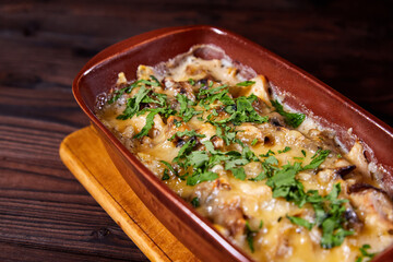 Baked meat with mushrooms and cheese. Al forno. Close-up, selective focus