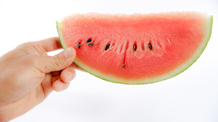 Watermelon cut in half, knife placed next to the watermelon, decorated with small pieces