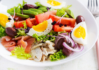 Ketogenic diet breakfast. Salt salmon and baked dorado salad with greens, tomatoes, eggs and avocado. Zero waste, eco friendly concept.