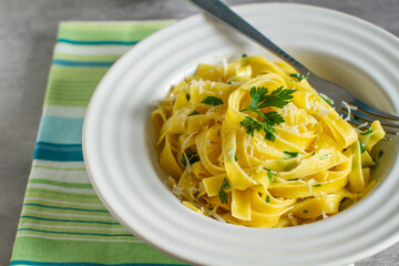 italian pasta fettuccine with olive oil , parsley and parmesan cheese
