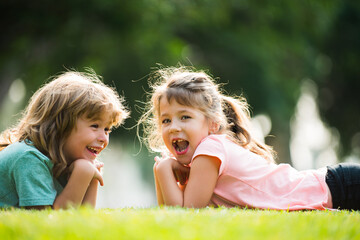 Happy kids couple in love. Children relationships. Little boy girl outdoors in park.