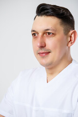 Young male doctor in a white surgical suit.Isolated on a white background