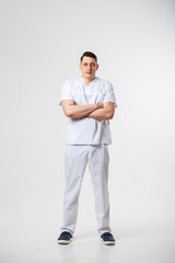 Young male doctor in a white surgical suit.Isolated on a white background