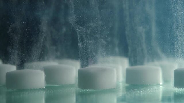 close-up of white tablets in water dissolving