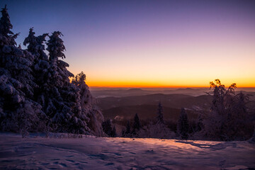 winter landescape in the rays of rising sun at mountain covered by snow 