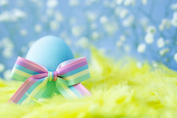 Easter conceptual  postcard  .  Easter  blue  egg   with  ribbon   bow   colors of the rainbow as a flag of gays and lesbians as well as Easter eggs. Homosexual concept