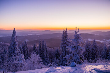
sunrise on a ski slope in the snowy mountains