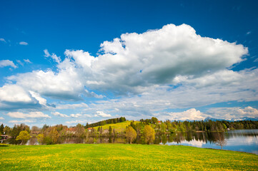 panoramic landscape with meadow and lake in Bavaria, Germany, at springtime