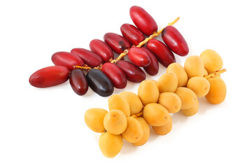 Yellow and red sprigs of dates isolated on white