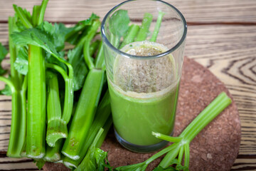 Healthy Celery diet for the treatment of incurable mysterious diseases. Fresh celery juice squeezed out on a juicer.drink, vegetable juice, studio shot