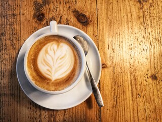 directly above view of cappuccino on wooden table