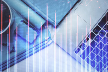 Double exposure of forex graph drawing over desktop background with computer. Concept of financial analysis. Top view.