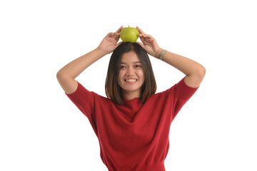 Asian girl put the apple on his head and smile happily, on white background.