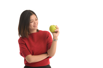 Asian woman is holding an apple with her left hand and look interesting on white background.