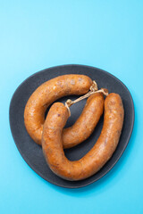 typical portuguese smoked sausages alheira on ceramic background