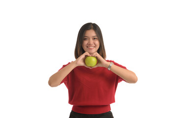Asian woman is holding an apple with both hands attached to her chest, on white background.