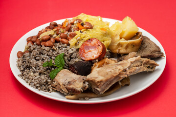 typical portuguese dish boiled meat, smoked sausages and vegetables on white dish