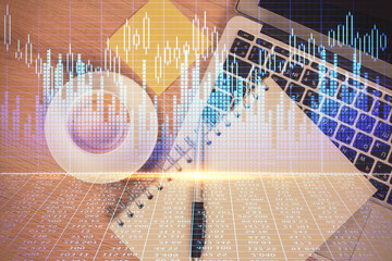 Double exposure of forex chart drawing over table background with computer. Concept of financial...