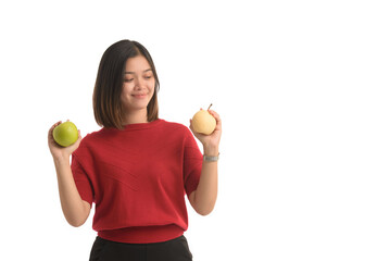Asian woman is holding an apple with both hands attached to her chest, on white background.