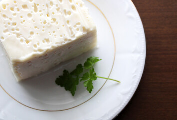 Full fat cheese in the plate, top view