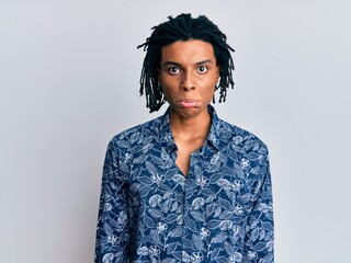 Young african american man wearing 80s style shirt depressed and worry for distress, crying angry and afraid. sad expression.