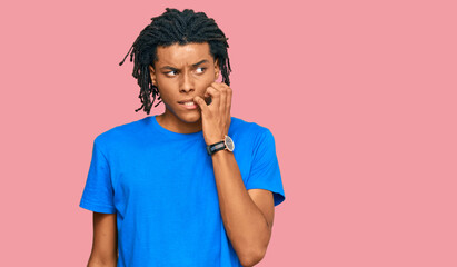 Young african american man wearing casual clothes looking stressed and nervous with hands on mouth biting nails. anxiety problem.