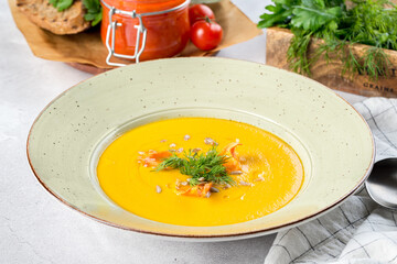 Carrot soup in a white plate filmed for the menu