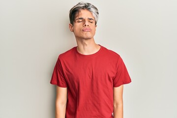 Young hispanic man wearing casual clothes looking at the camera blowing a kiss on air being lovely and sexy. love expression.