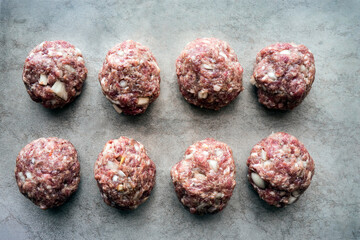 Homemade meat cutlets made by hand on a dark table. Top view
