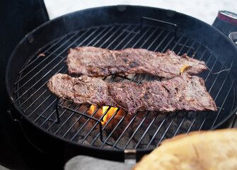 Hanging tender or onglet steak of beef on the grill. Grilling meat. BBQ