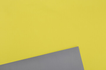 Illuminating yellow and Ultimate Gray pastel paper texture background, Geometric flat lay background.