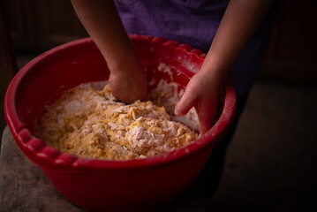 mixing flour with egg and milk by the housewife. preparing ingredients for traditional homemade cakes