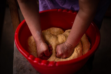 housewife kneading the dough by hand. preparation of the recipe for traditional Romanian homemade cakes known as cozonac