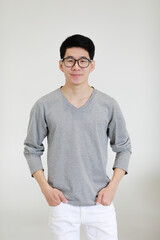 Portrait of a young and handsome Asian man on white background