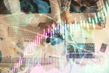 Double exposure of man and woman working together and financial graph hologram drawing. market analysis concept. Computer background. Top View.